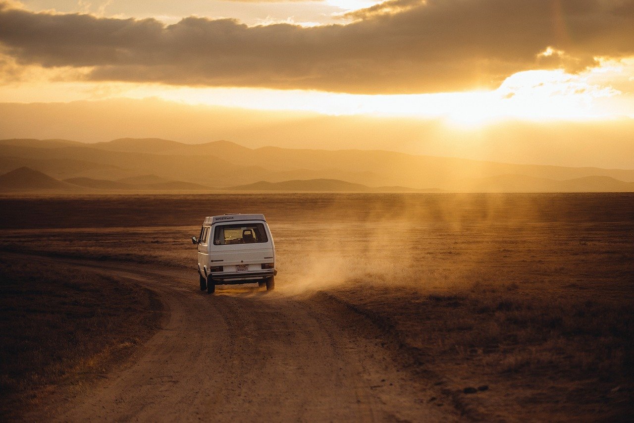 volkswagen campervan on a dirt road