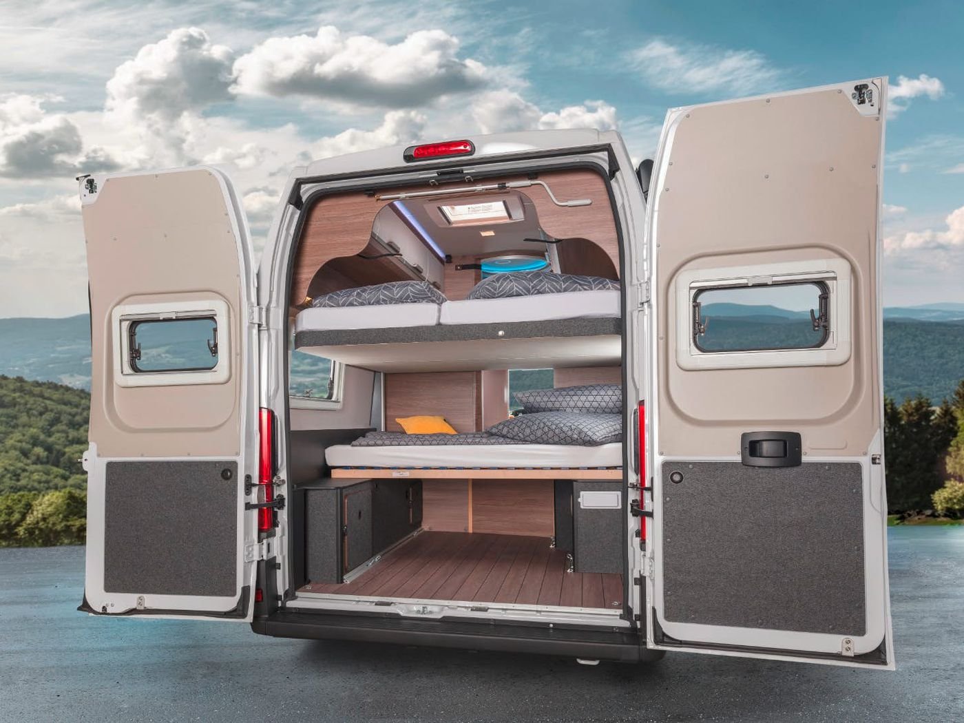 a pale pink campervan with lift beds