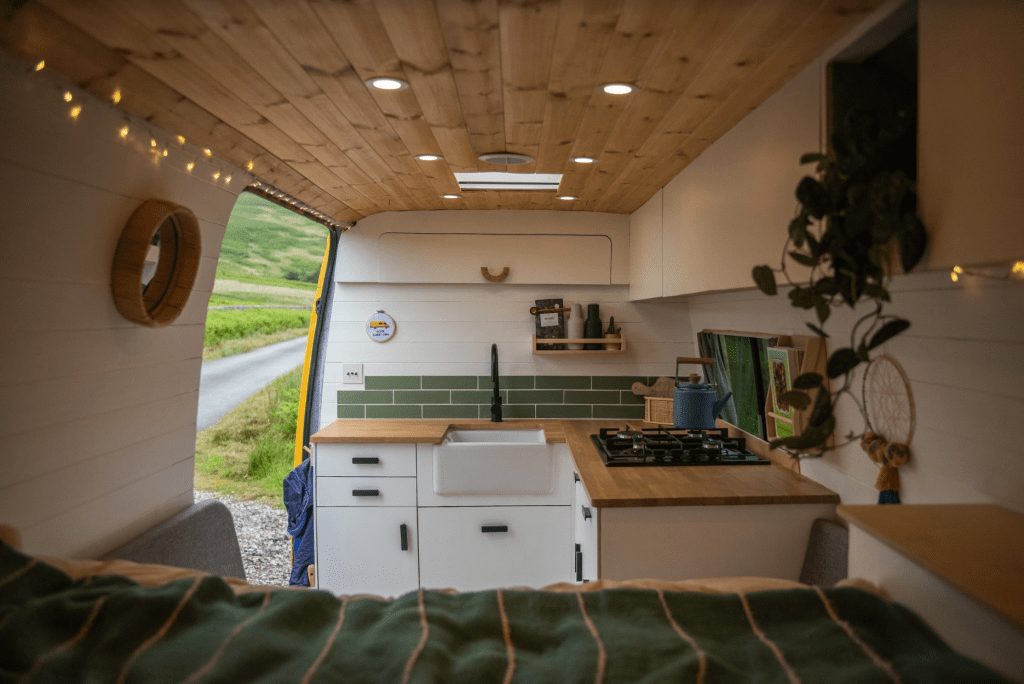 the interior of a self build camper showing a bright kitchen space