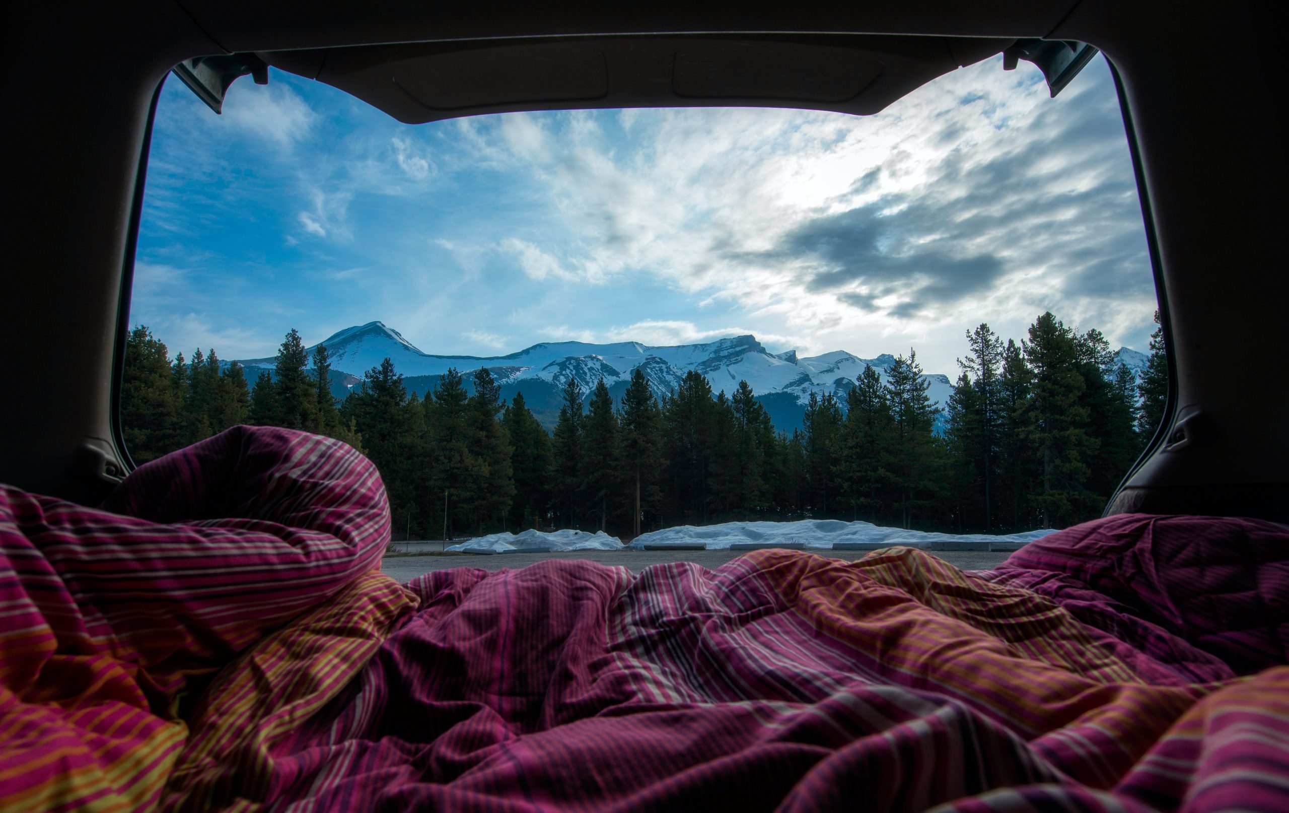 the view from a back of the van campervan bed overlooking a mountain scene