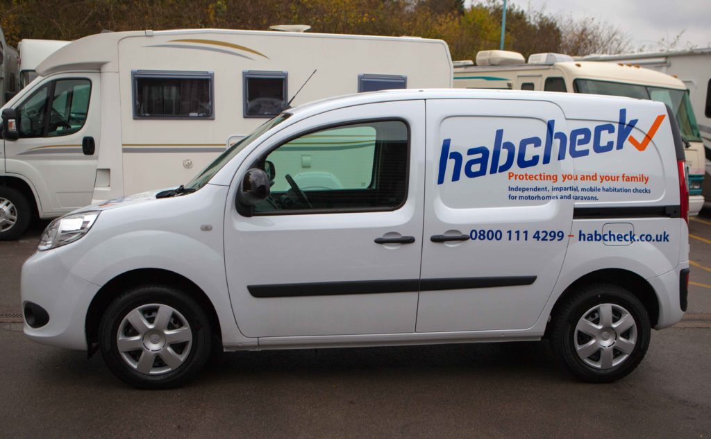 an expert checking a campervan for sale on behalf of a potential buyer