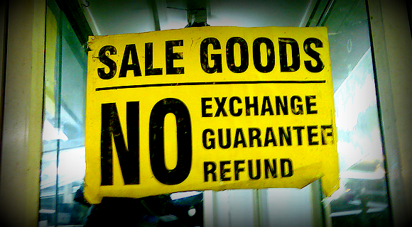 a poster in a shop window saying sale of goods