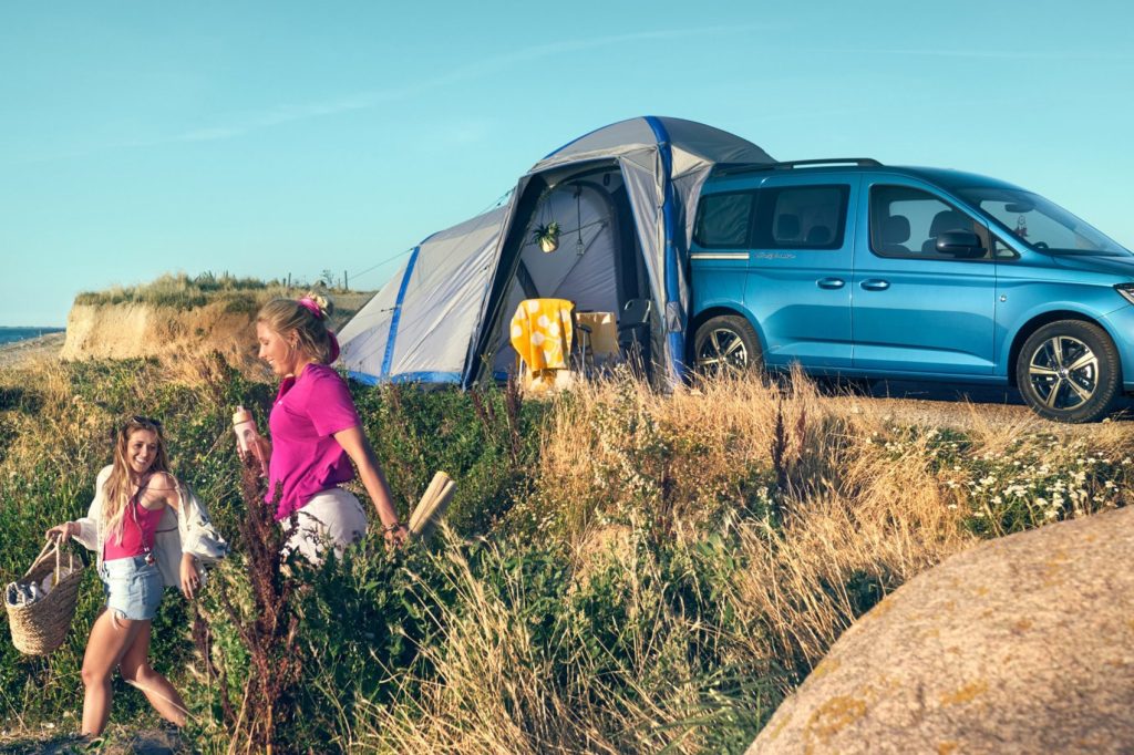 volkswagen caddy campervan in blue with a tent attachment